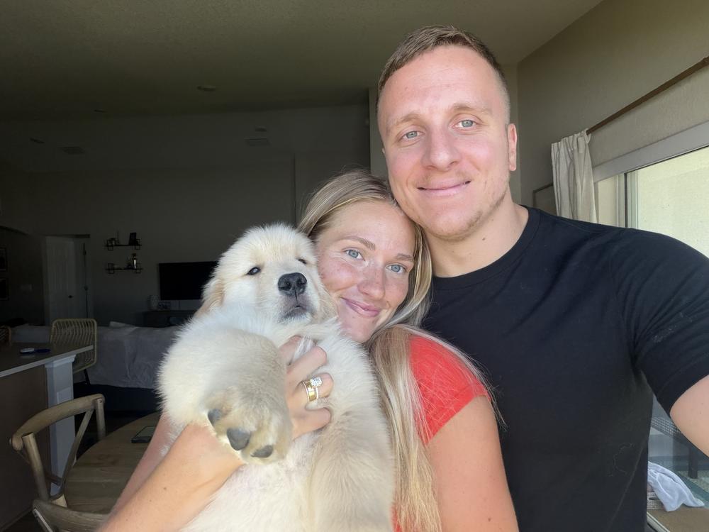 Dylan, owner of Garage Maid, with his wife and their puppy