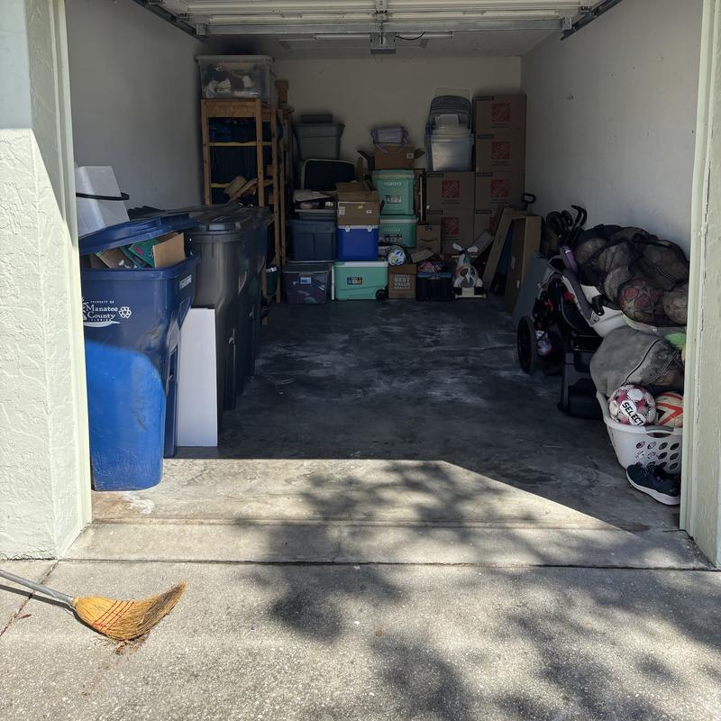 The same one-car garage after, with a clear floor and items along the back wall