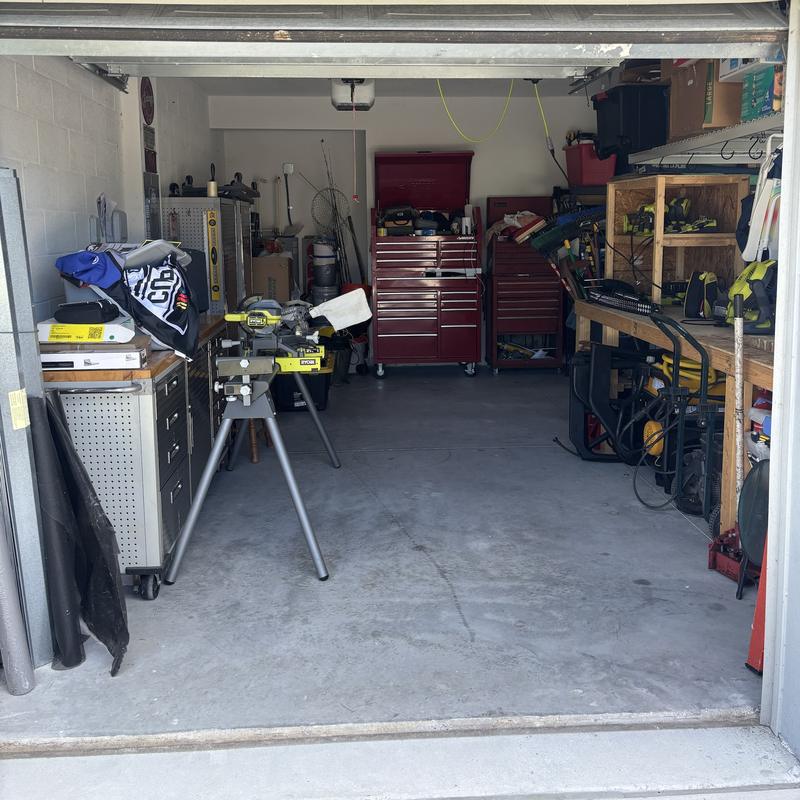 The same workshop after, with tool chests and benches clear and the floor open